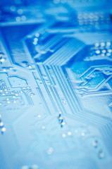 Printed circuit Board with microchips and conductors close-up, soft focus, vertically