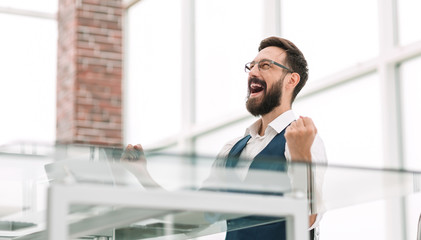 Fototapeta premium very happy businessman sitting at the office Desk