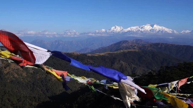 Tibetan prayer flag or Lung ta and Kangchenjunga high mountain range view from the Sandakphu , Darjeeling,  India, Zoom out.