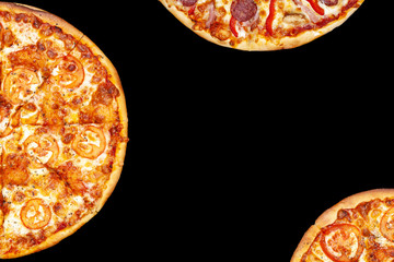 Fresh pizza with meat beaf chicken pork, tomatoes, vegetables, ushrooms on dark black background closeup