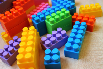 Children's block color meccano a light wooden background.