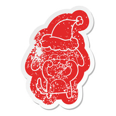 cartoon distressed sticker of a tired dog wearing santa hat