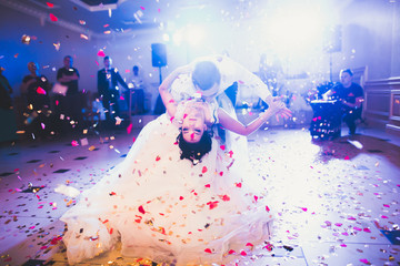 First wedding dance of newlywed couple in restaurant