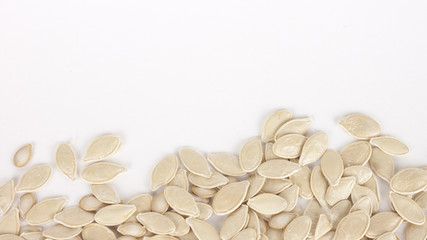 raw superfoods pumpkin seeds on white background