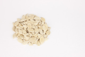 raw superfoods pumpkin seeds on white background
