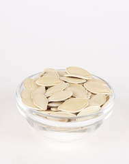 raw superfoods pumpkin seeds on white background