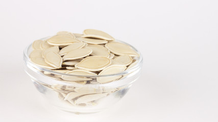 raw superfoods pumpkin seeds on white background