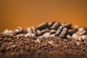 Close up Coffee beans over the cofee powder