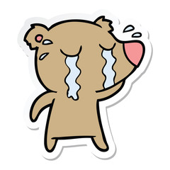 sticker of a cartoon crying bear