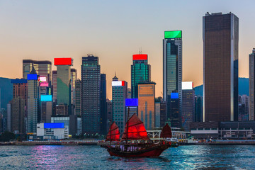 Fototapeta premium Hong Kong harbour, Traditional Chinese wooden sailing ship with red sails in Victoria harbour, Hong Kong.
