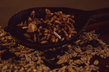 spoon with nuts, different shades of brown, rustic, healthy and aromatic characteristics.