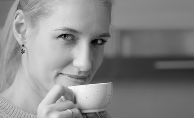 Portrait of a  mid age woman with cup of coffee.