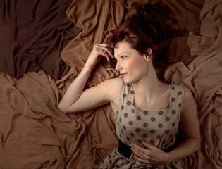 Attractive woman in polka dot dress with satin shawls.
