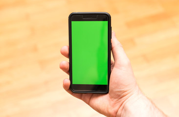Male hand with Smartphone. Chroma key. Place for your advertisement.