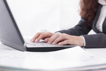 Fototapeta premium Woman working at home office hand on keyboard close up