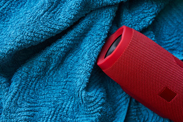 Portable stereo speaker on blue towel