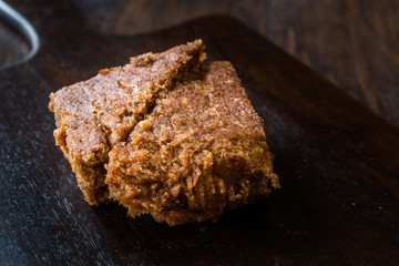 Organic Date Fruit Paste Dough on Dark Wooden Surface.