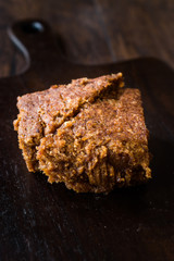 Organic Date Fruit Paste Dough on Dark Wooden Surface.