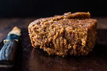 Organic Date Fruit Paste Dough on Dark Wooden Surface.