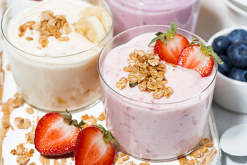 sweet yoghurts with fruits and berries for breakfast, closeup