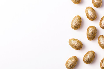 Gold glitter easter eggs on a plain white background