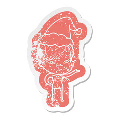 cute cartoon distressed sticker of a girl with hipster haircut wearing santa hat