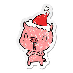 happy distressed sticker cartoon of a pig wearing santa hat