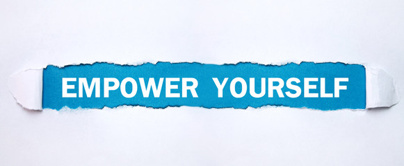 Text Empower Yourself on torn paper.