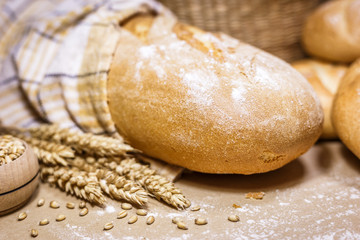 Fresh bread and wheat on a rustic background