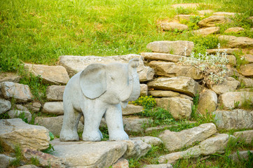 Fototapeta na wymiar A stone elephant standing on a tourist path.
