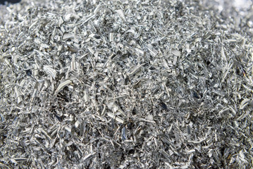 The scrape of aluminium pieces on the tray. The cutting chip of turning processing.