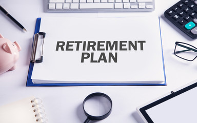 Text Retirement Plan with business objects on the desk.