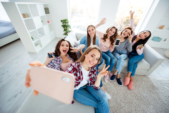 Close up photo cheerful beautiful she her ladies big family roommates telephone show v-sign say hi having fun best buddies make take selfies excited amazed bright white room girls day night indoors