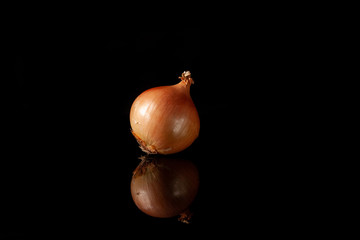 onions on a black background with reflection