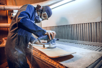Carpenter using circular saw for cutting wooden boards. Construction details of male worker or...