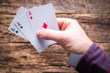 card sharper holds cards and aces in the sleeve