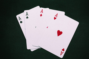 four aces on a green background closeup