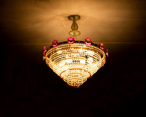 a picture of ceiling hanging lamp hanged under a roof during durga puja