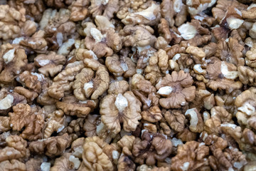 Lots of shelled walnuts. Food background. Close-up. Selective focus.