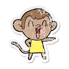 distressed sticker of a cartoon laughing monkey