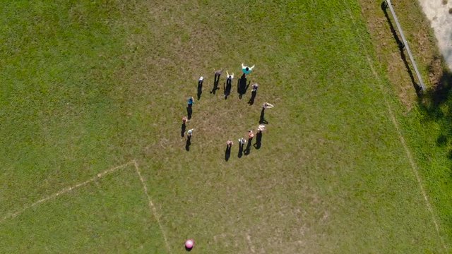 A group of children playing with a lawn mower. Exterior from above. 4k