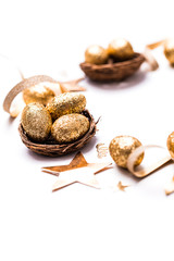 Golden glitter eggs in a nest. Easter background. Finance concept