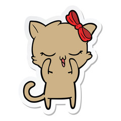 sticker of a cartoon cat with bow on head