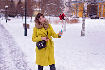 Young Asian girl walks through the park in winter