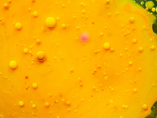 Abstract background of yellow glittering bubbles. Close up macro shot. Blurred background. Selective soft focus. Yellow universe, abstract background. Glittering spheres, abstract pattern