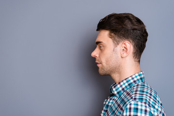 Close up side profile photo attractive amazing he him his man ideal perfect hairdo styling look interest empty space wearing casual plaid checkered shirt jeans denim outfit isolated grey background