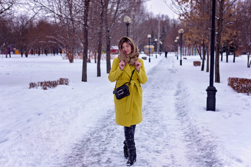 Young Asian girl walks through the park in winter