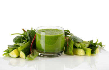 Fresh organic smoothie surrounded by vegetables isolated on white background