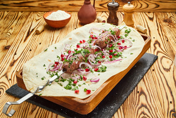 Lula kebab, Georgian dish with meat served by onions and greens in pita bread