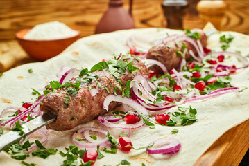 Lula kebab, Georgian dish with meat served by onions and greens in pita bread